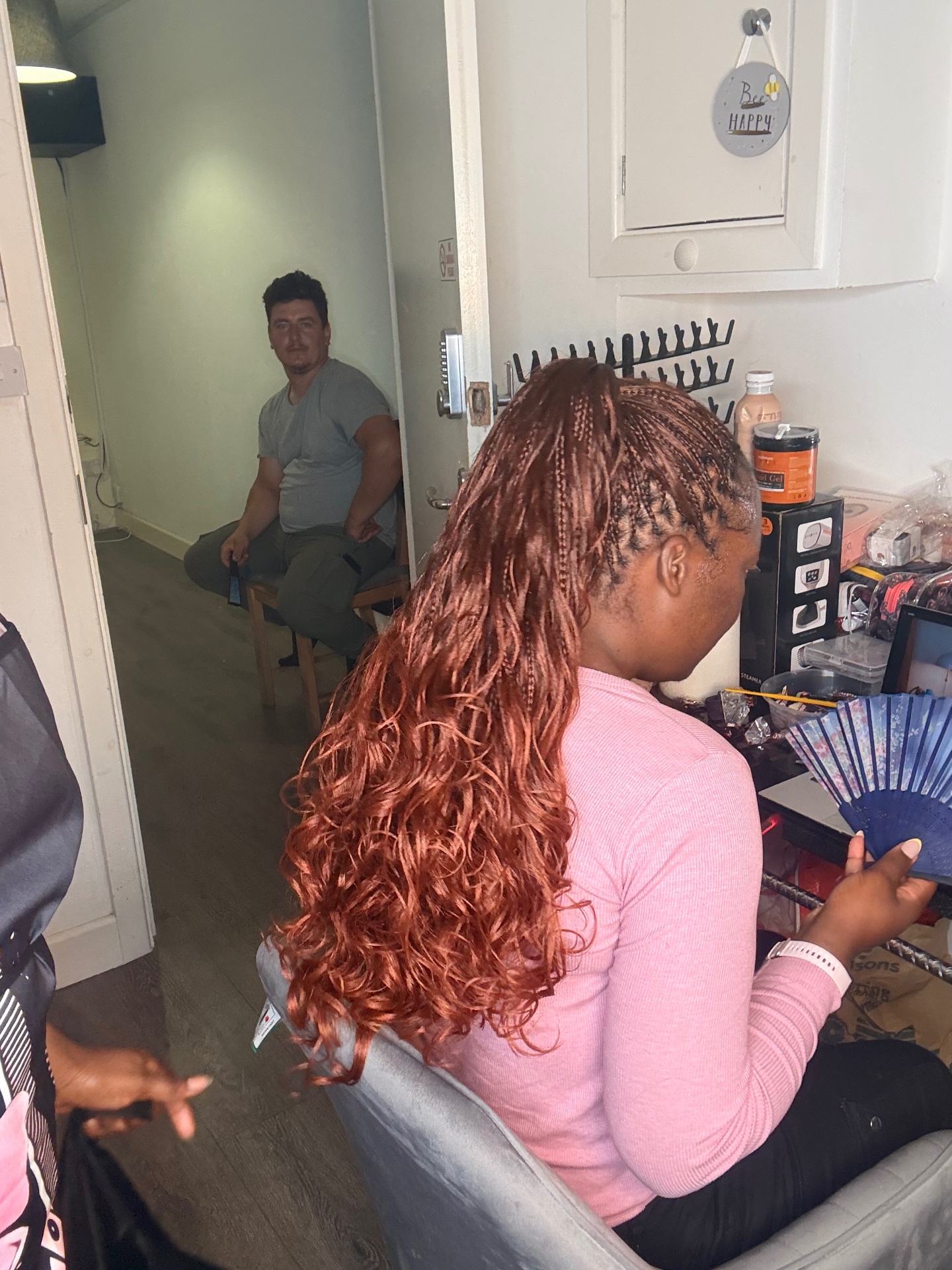 Copper boho braids with curly ends in a high ponytail