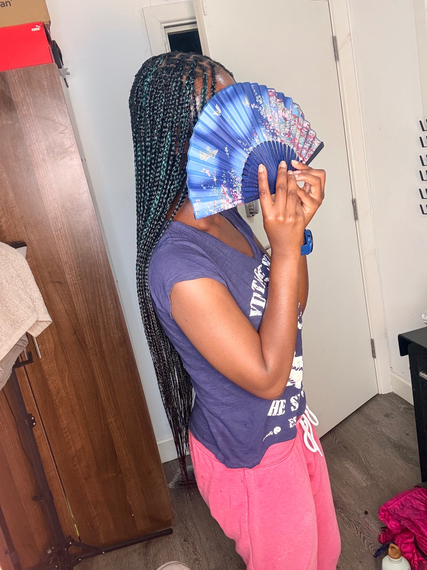 Long kids knotless braids with teal tones shown from the side at the Leeds studio