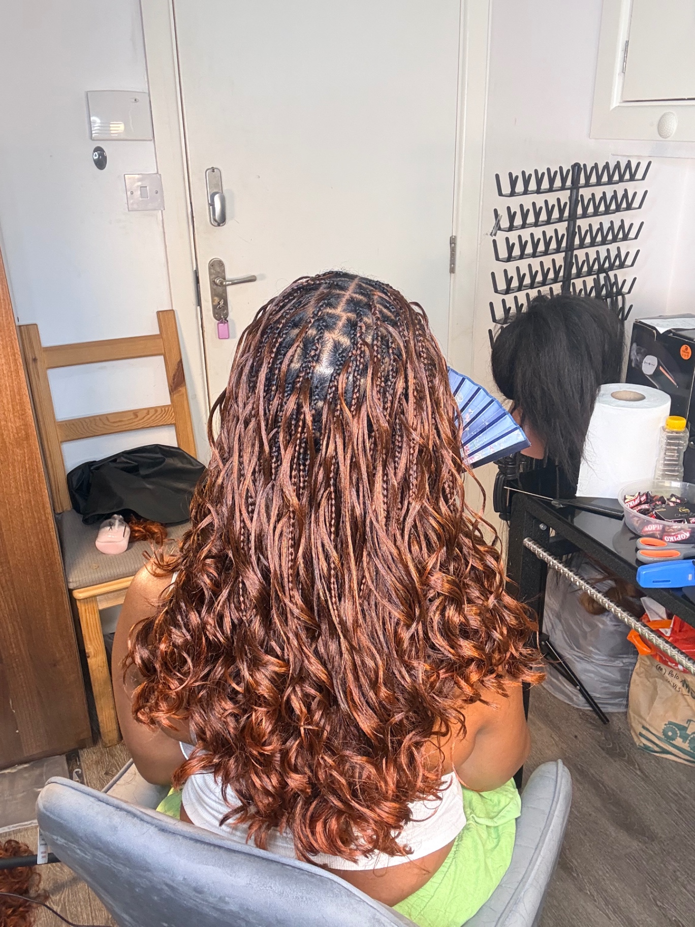 Copper knotless French curl braids with bouncy curly ends