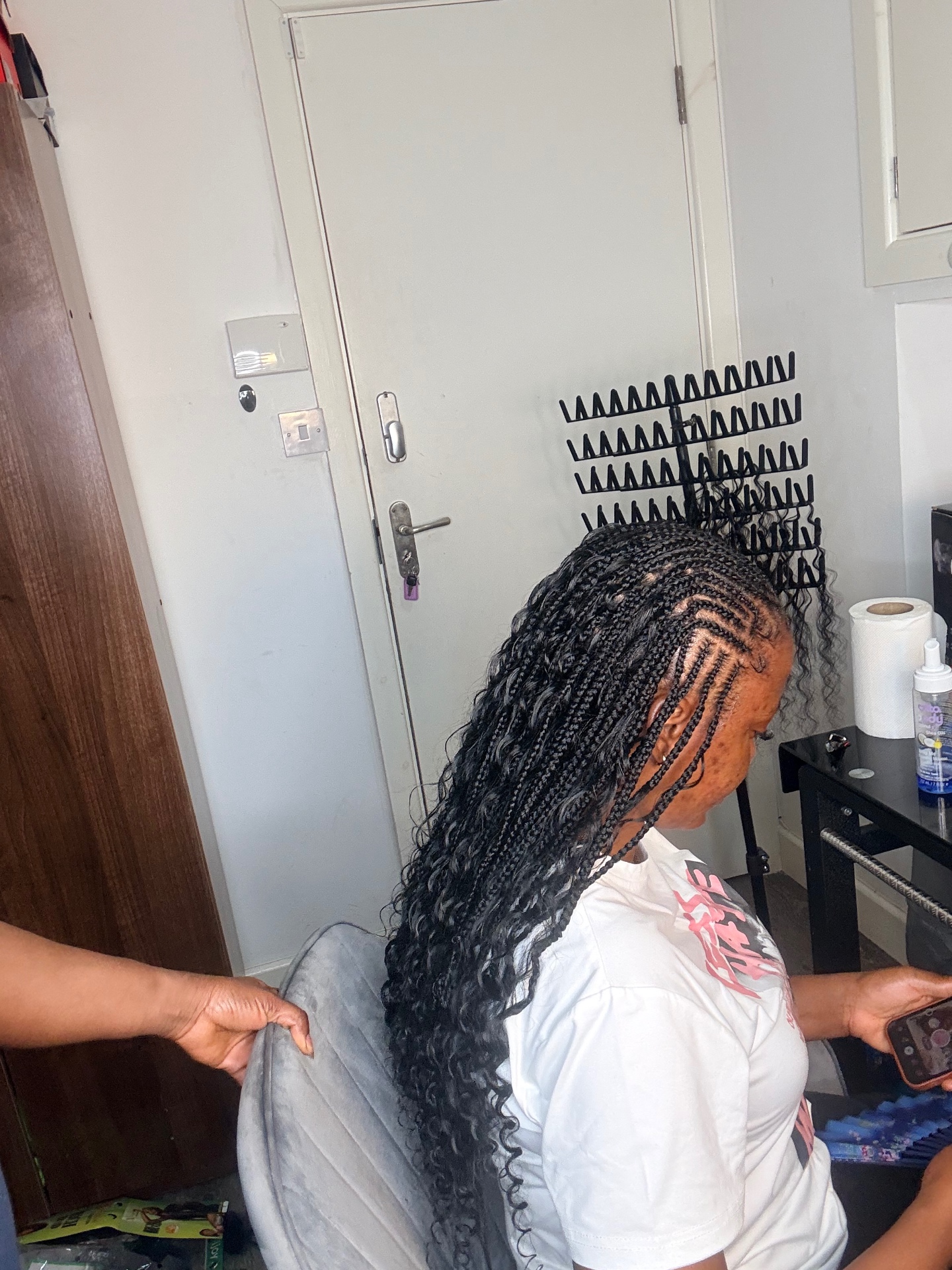 Knotless boho braids with curly ends, styled at the studio