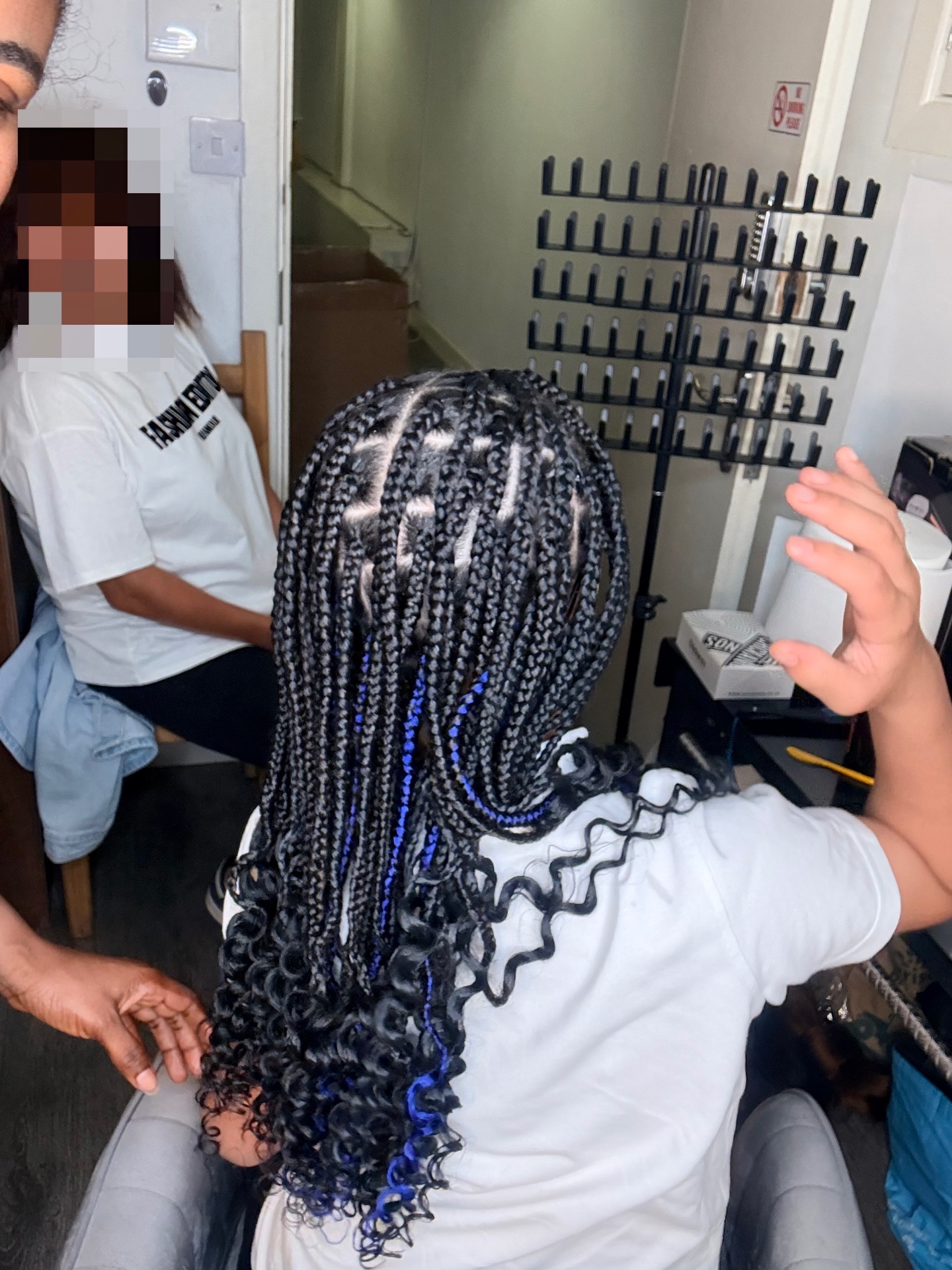 Kids box braids with blue accents and curly ends styled at the Leeds studio